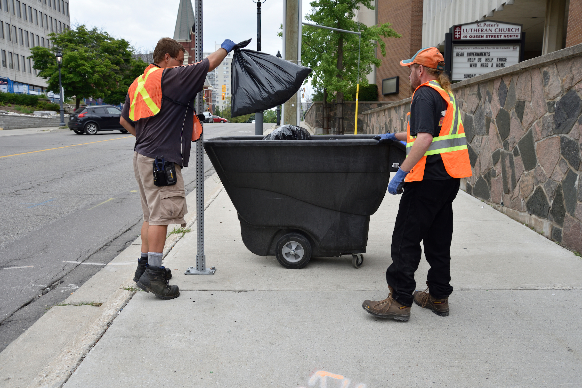 Sean and Cornelius, members of Clean Team II, collecting garbage in downtown Kitchener as part of The Working Centre’s Job Café Projects.