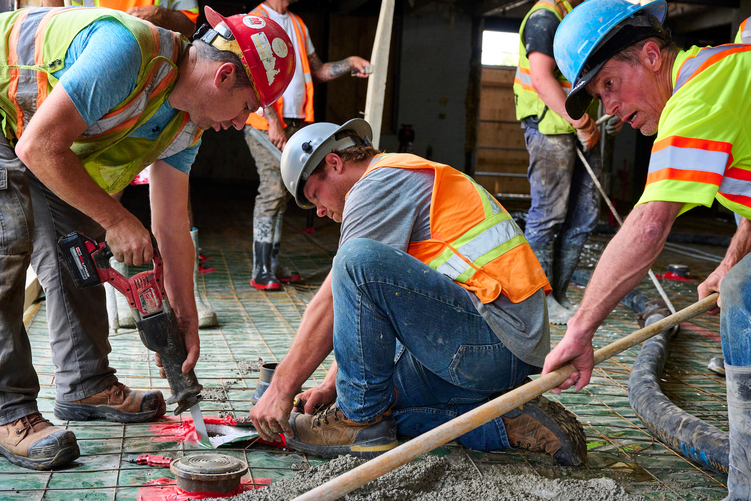 A mixed crew from Citacom and RM Custom pour a concrete floor during renovations at St. John's Kitchen in Kitchener, Ontario.