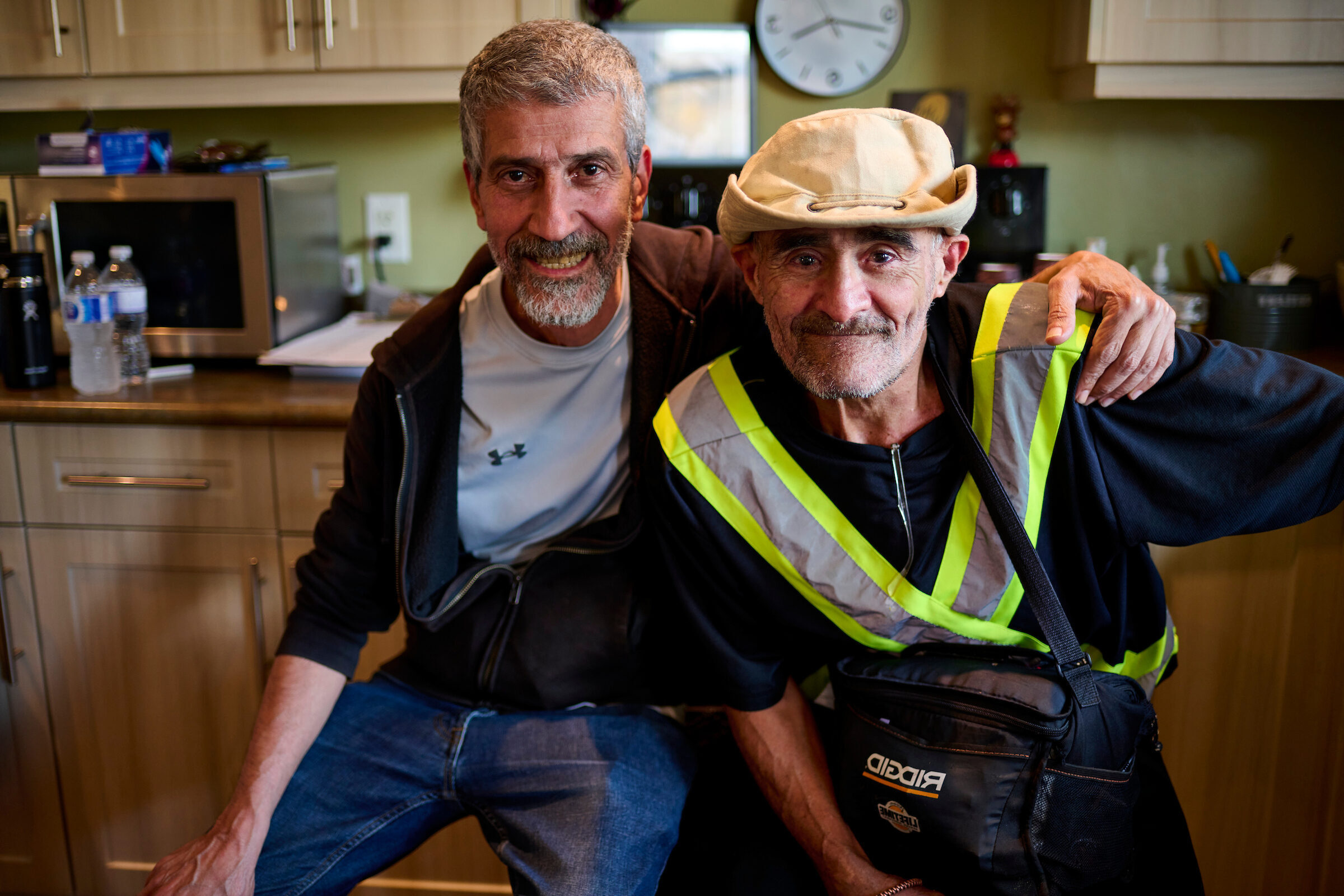 Romulo and Kajaw sharing a moment of camaraderie at 87 Victoria, Kitchener, Ontario, in a safe consumption space.