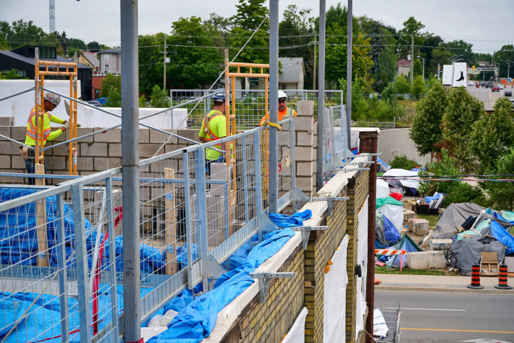 Workers on scaffolding construct the third floor of the Making Home project at 97 Victoria in Kitchener, Ontario, 2024.