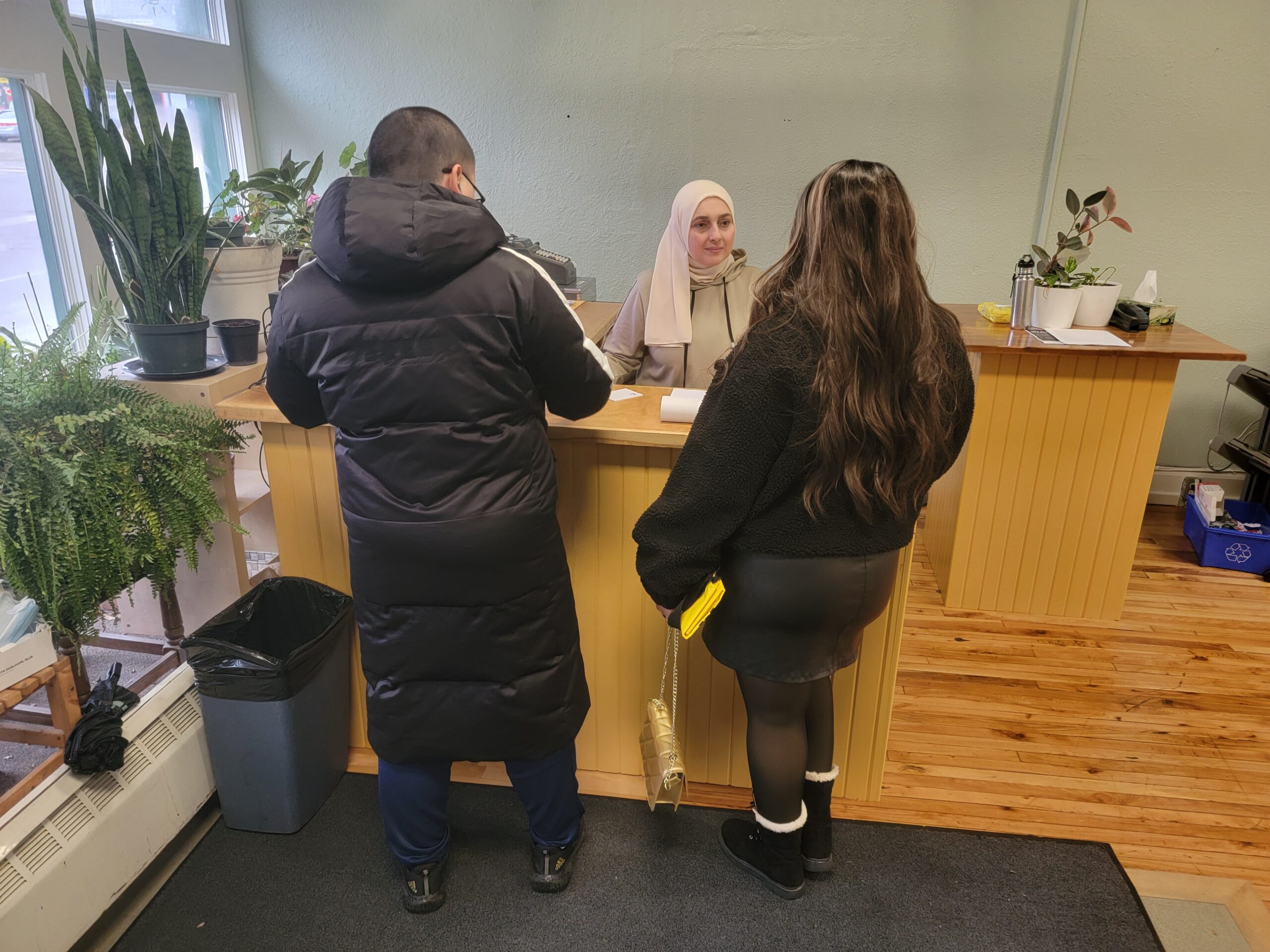 Job seekers being assisted at the Job Search Resource Centre reception in Kitchener, Ontario, with a welcoming and supportive environment.