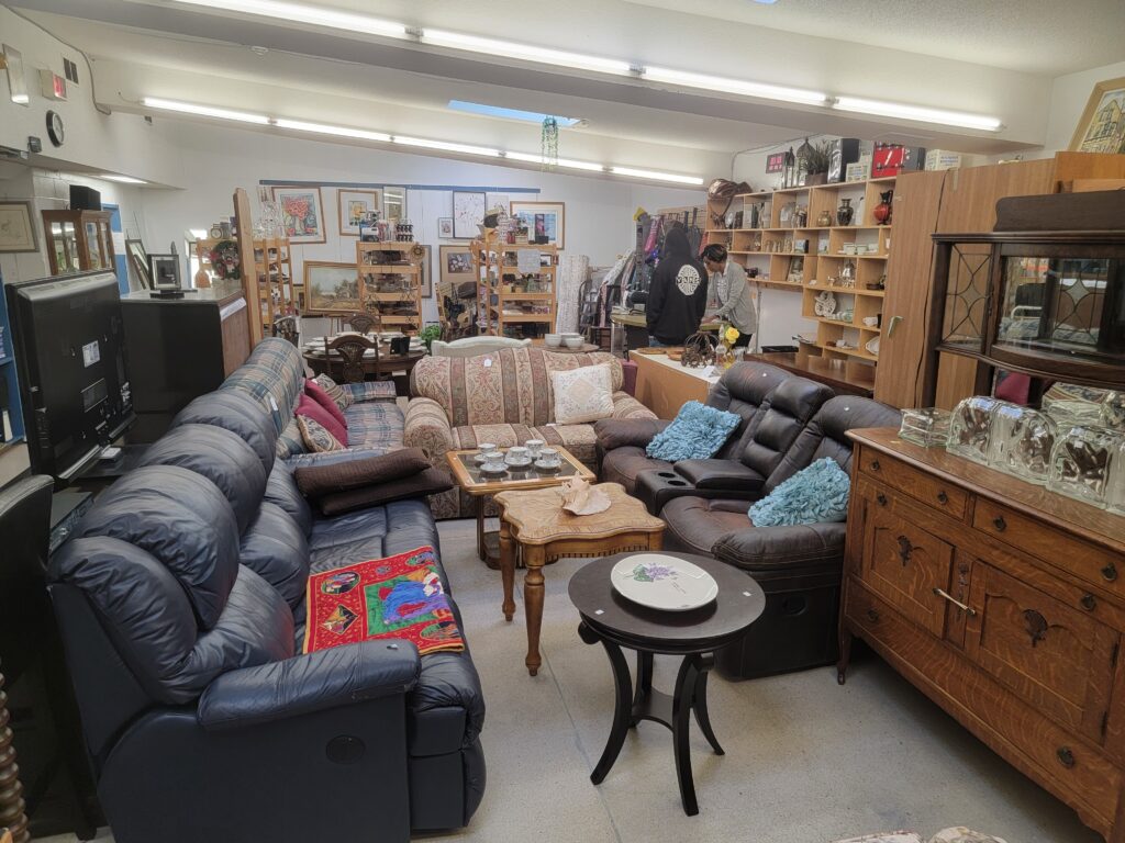 Assorted furniture including sofas, tables, and cabinets displayed in Worth a Second Look, a used furniture store in Kitchener, Ontario.