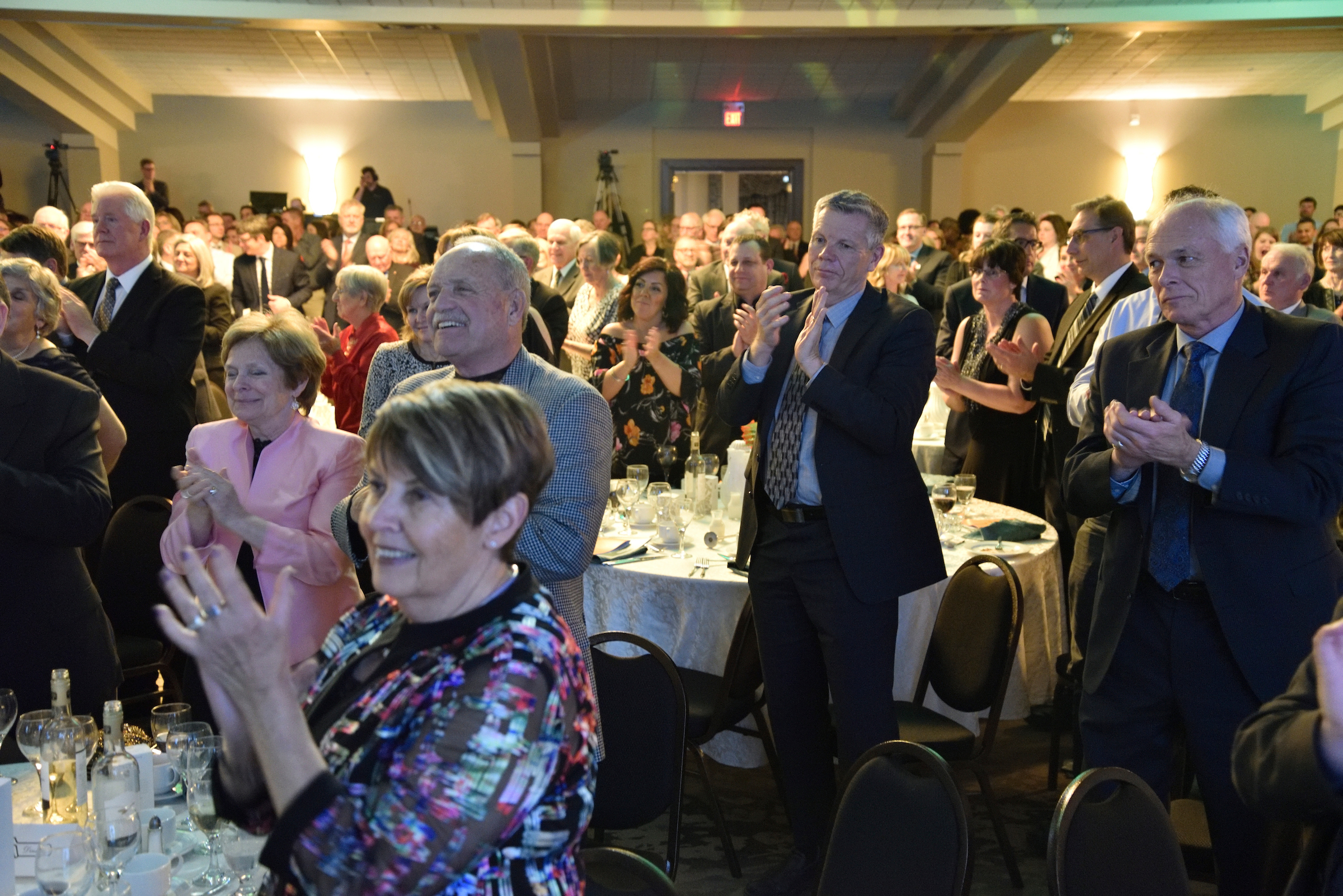 Audience giving a standing ovation at the 31st Annual Mayors' Dinner hosted by The Working Centre in Kitchener, Ontario.