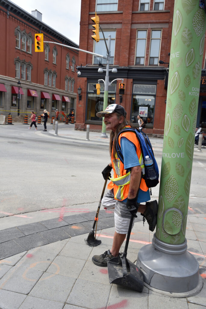 Clarence and Shawn from The Working Centre's Clean Team sweeping streets in downtown Kitchener as part of Job Café Projects.