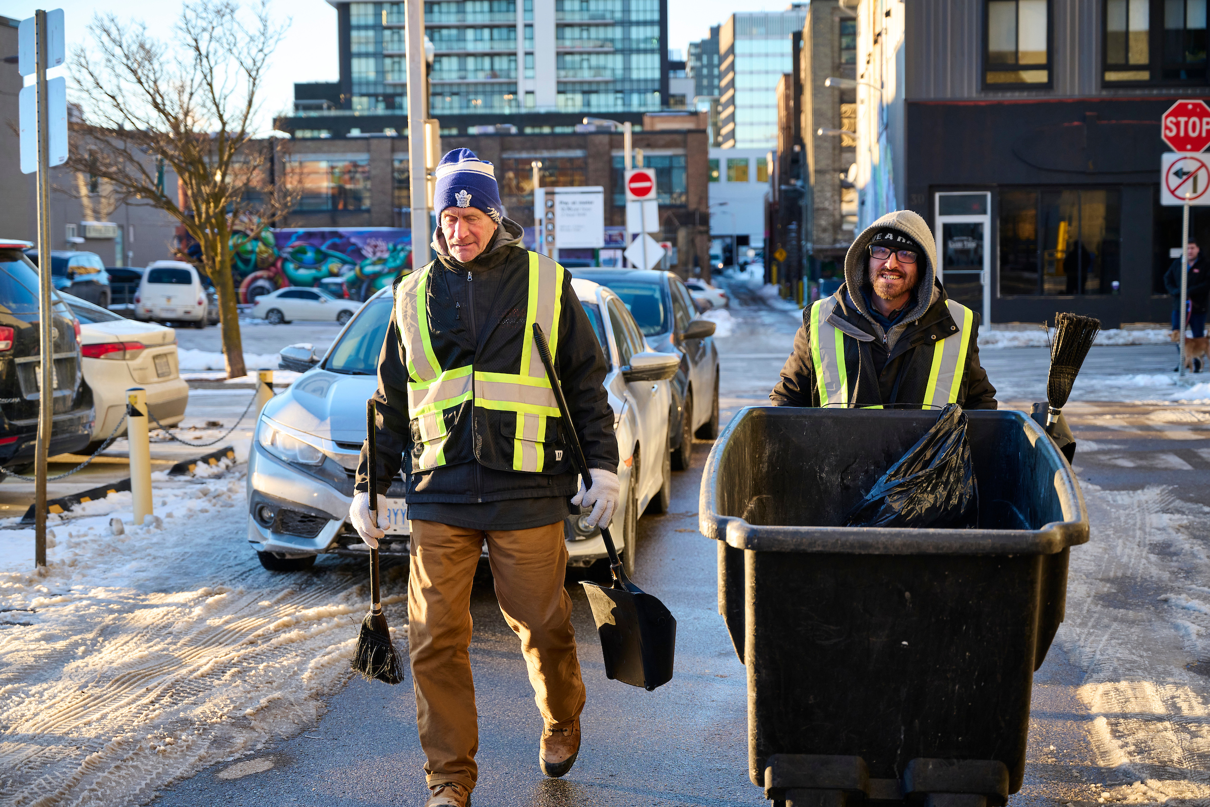 Two members of the Clean Team working on snowy streets in Kitchener, Ontario.