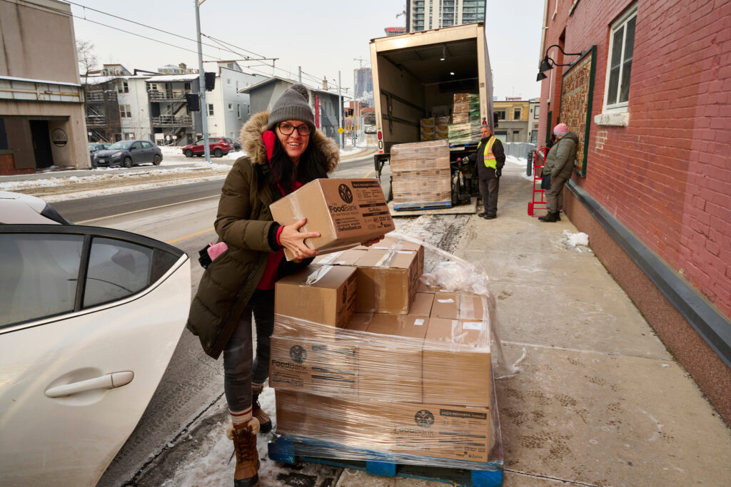 Outreach workers from SOS collecting hampers from the Food Bank of Waterloo Region for distribution to hotel and other clients in Kitchener, Ontario.