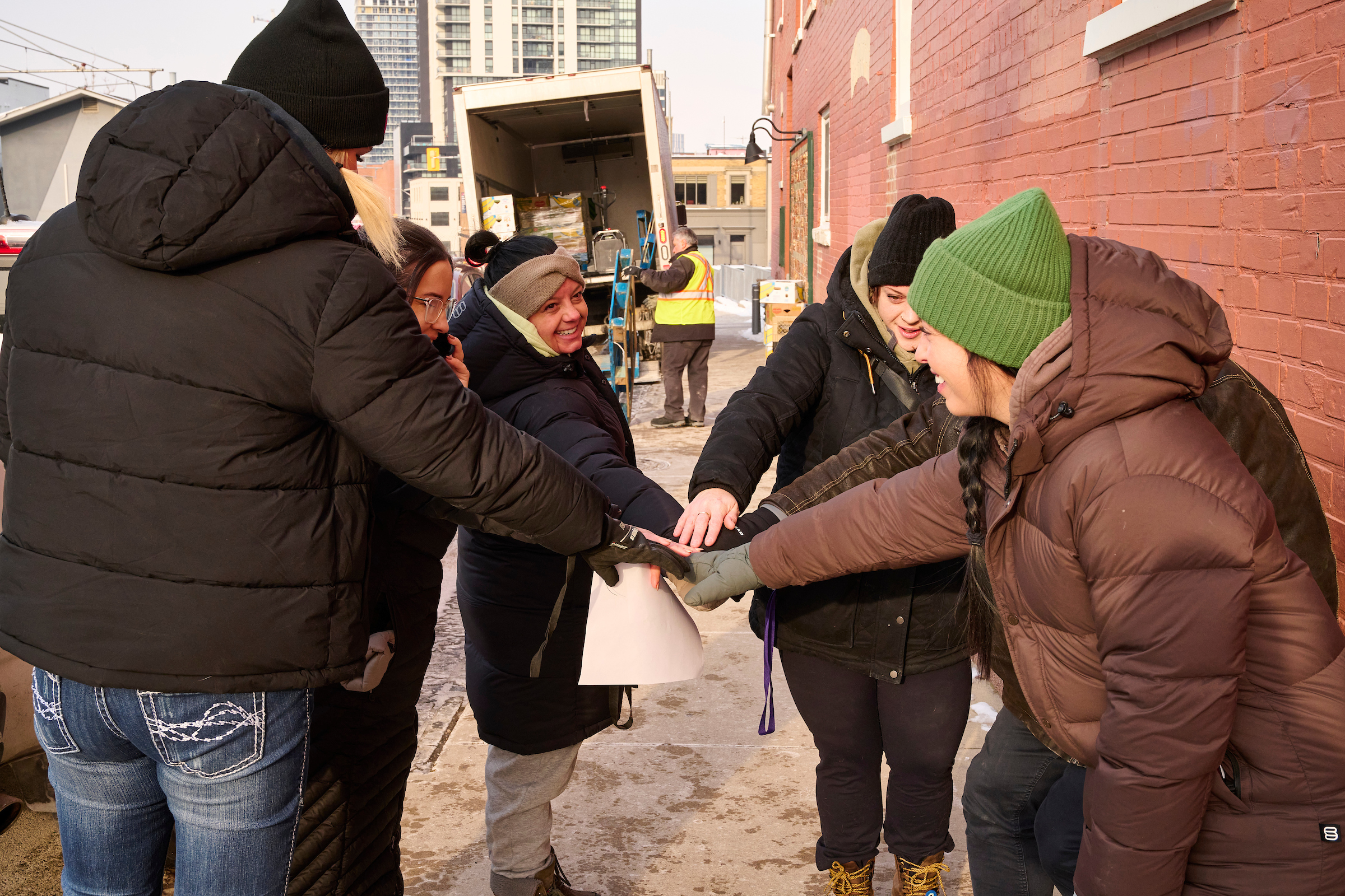 Group of SOS outreach workers preparing to distribute food bank hampers at The Working Centre.