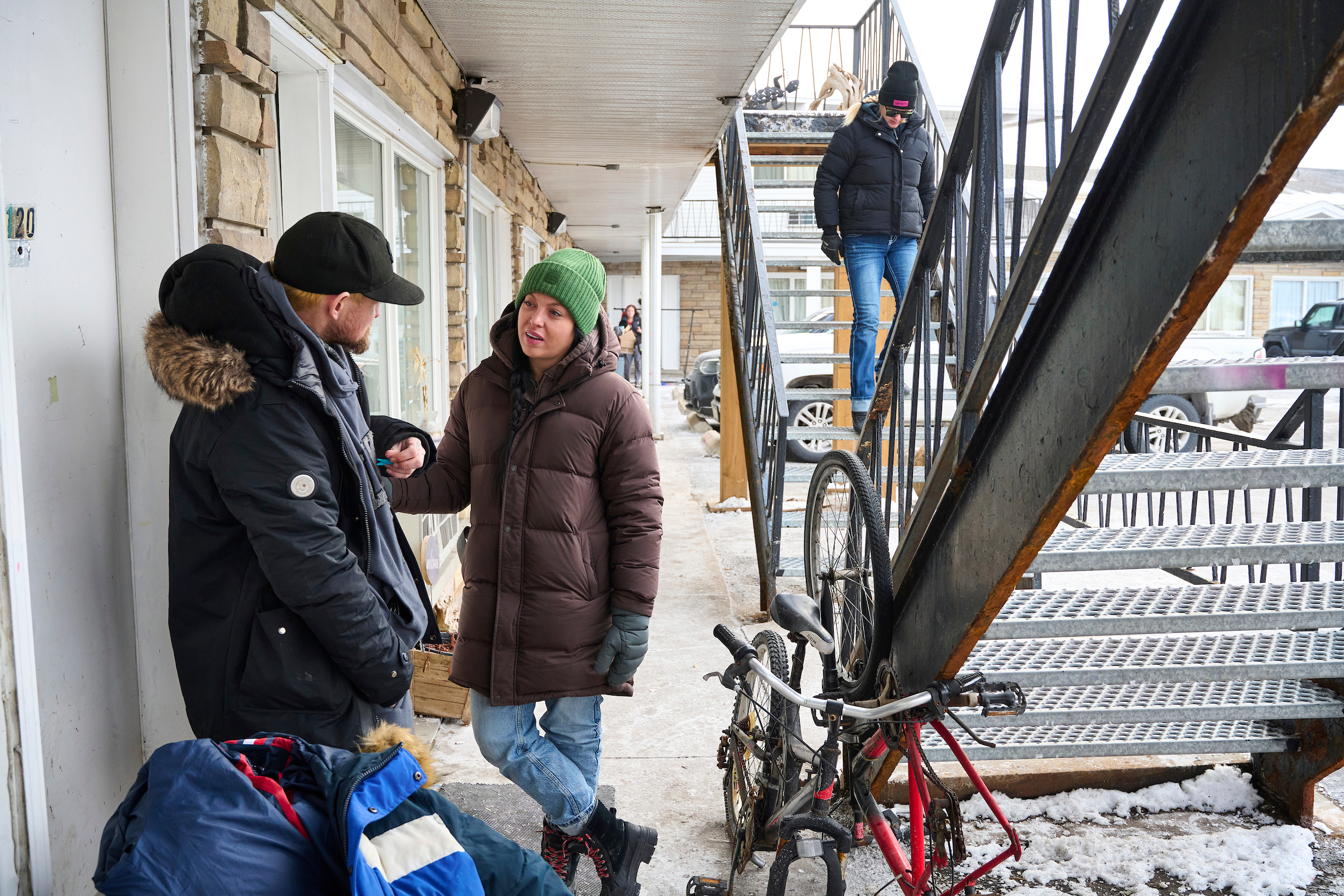 Kenny and SOS outreach worker Nikki Britton engage in a conversation during a food bank hamper delivery at a motel in Kitchener, Ontario.