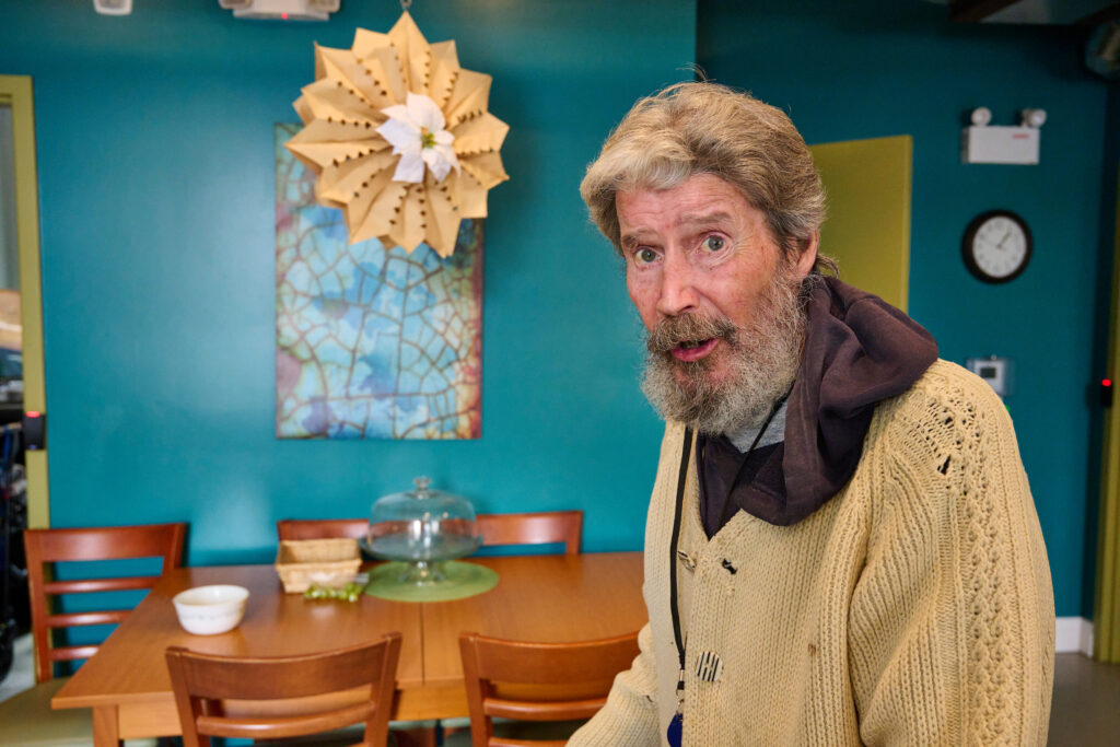 An unnamed resident standing in the Hospitality House ground floor kitchen, Kitchener, Ontario.