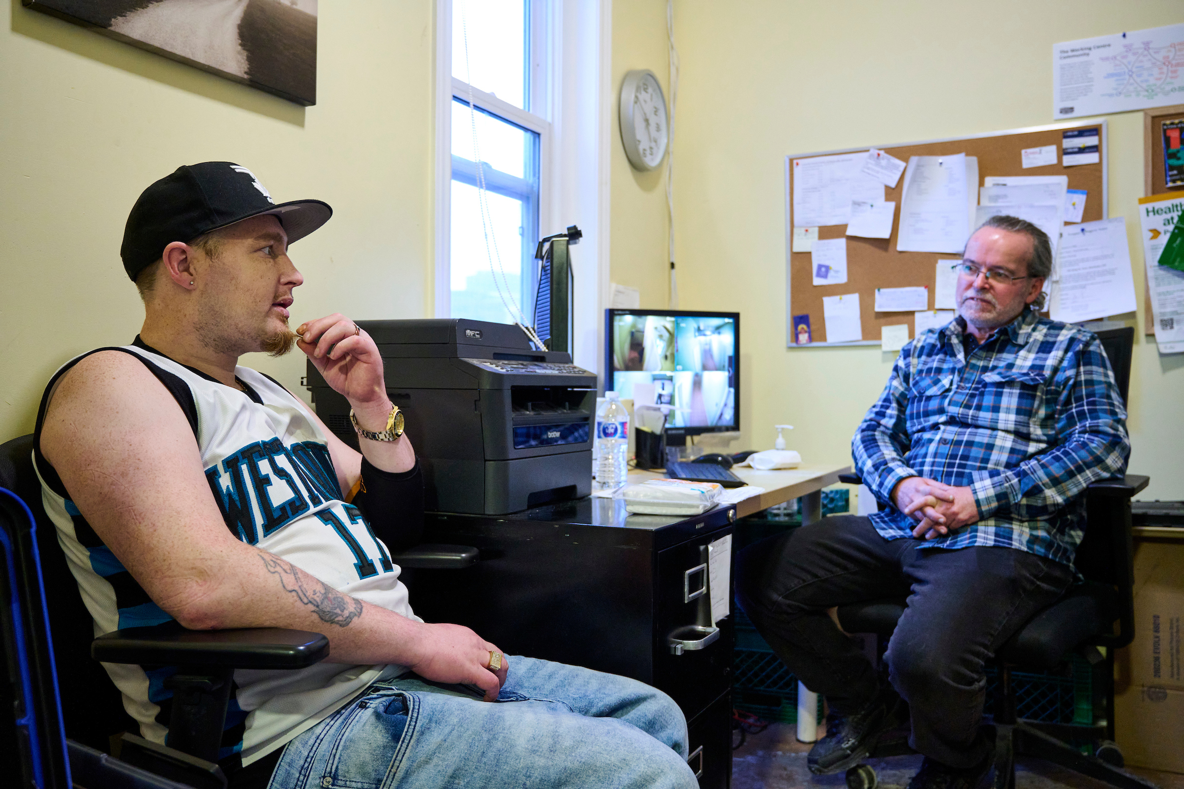 Dacota, a resident, speaking with Don Toomey, a housing support staff member, at the supportive housing office at 256 King Street East, Kitchener, Ontario.